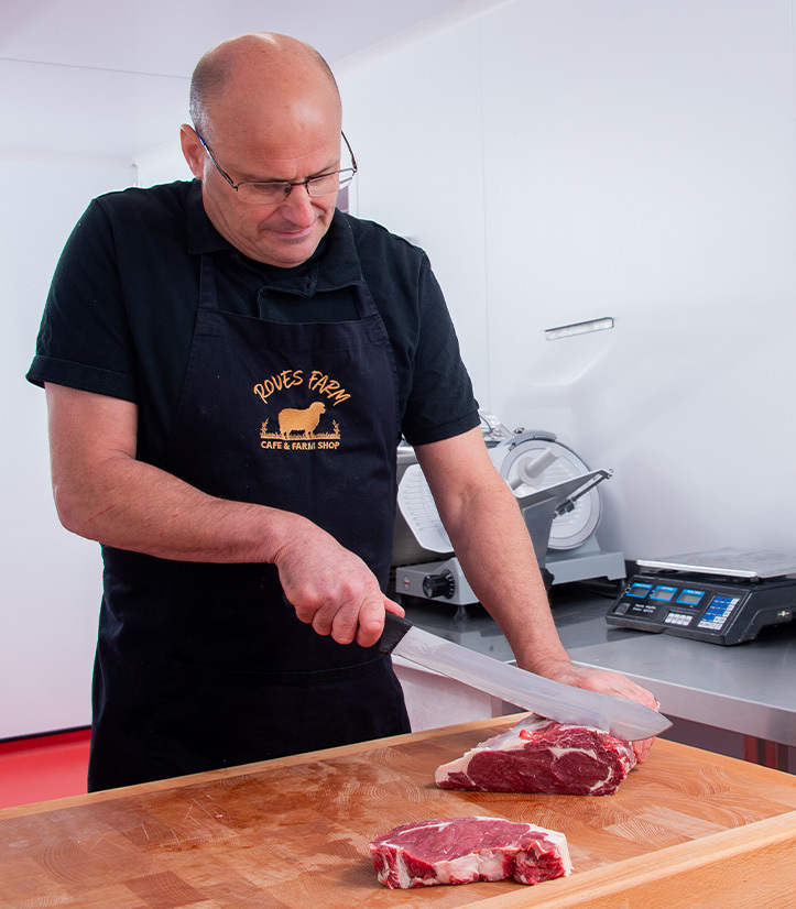 A butcher at Roves Farm cuts the perfect steak